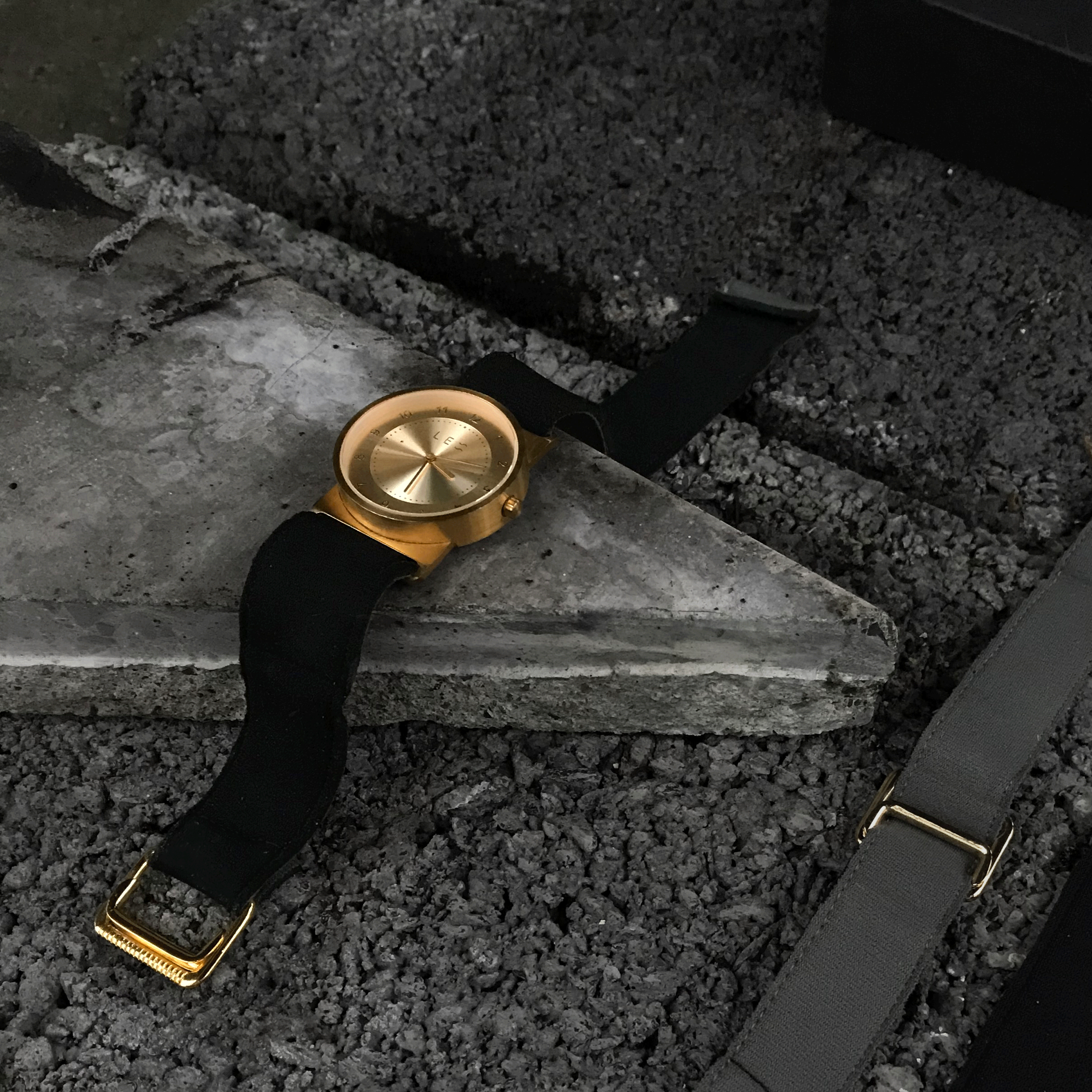 gold watch on concrete with modern design